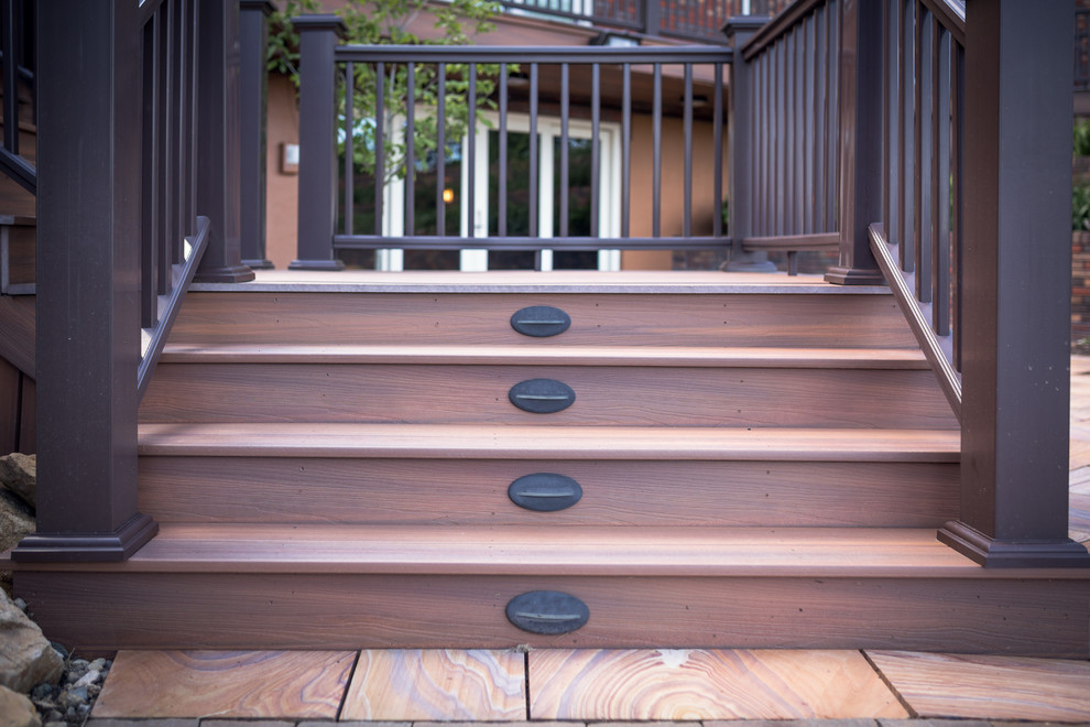 Example of a huge mountain style backyard outdoor kitchen deck design in Indianapolis with a roof extension