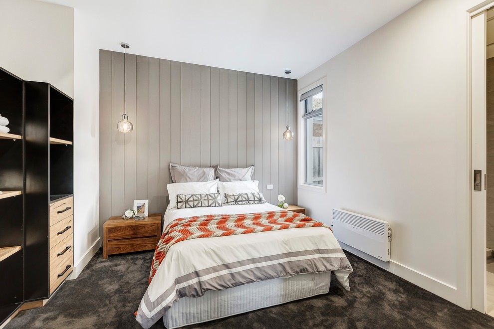Scandinavian master bedroom in Melbourne with white walls, carpet and grey floor.