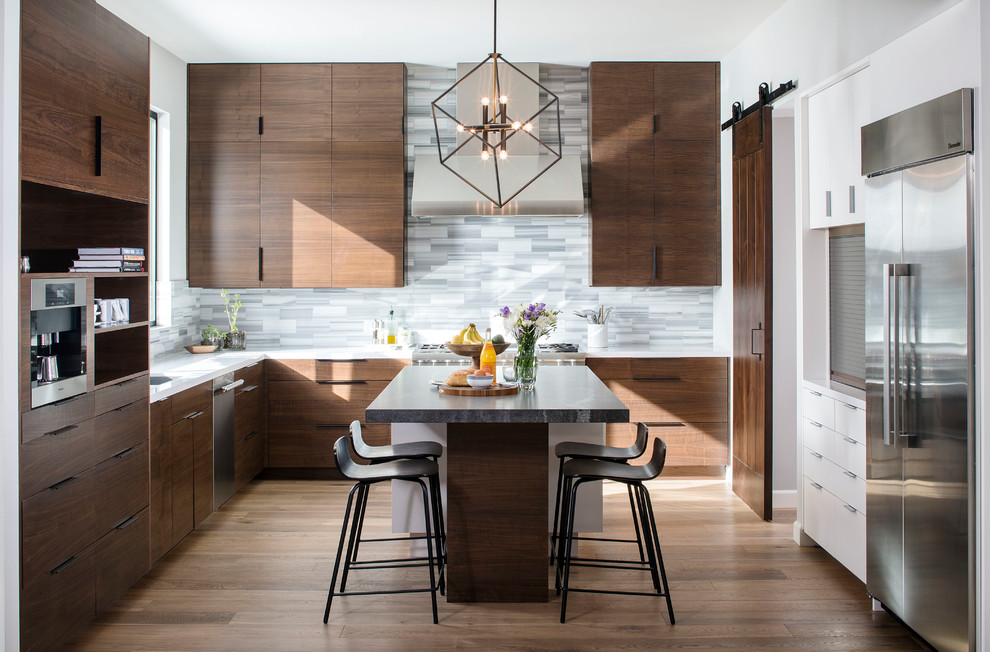 Inspiration for a contemporary u-shaped kitchen in San Diego with an undermount sink, flat-panel cabinets, dark wood cabinets, grey splashback, matchstick tile splashback, stainless steel appliances, dark hardwood floors and with island.