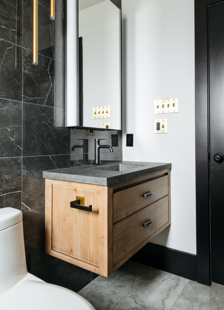 Inspiration for a contemporary shower room bathroom in Houston with flat-panel cabinets, medium wood cabinets, a one-piece toilet, black tiles, white walls, an integrated sink, grey floors, grey worktops, a single sink and a floating vanity unit.