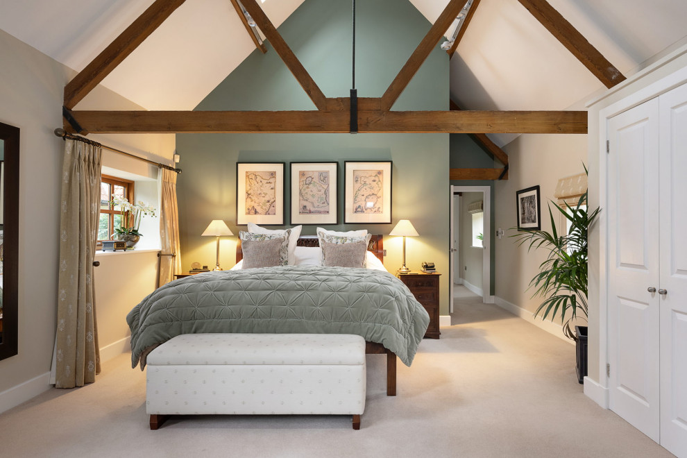 Design ideas for a large classic master bedroom in Hampshire with green walls, carpet and beige floors.