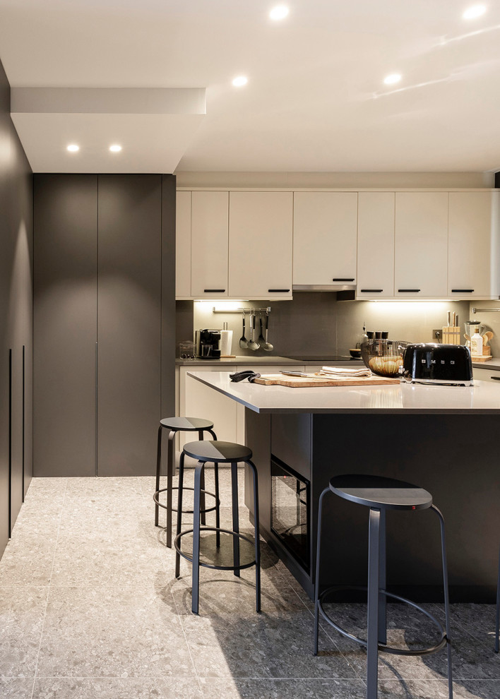 Design ideas for a large contemporary l-shaped open plan kitchen in Barcelona with flat-panel cabinets, beige cabinets, quartz benchtops, with island, grey splashback, grey floor and white benchtop.