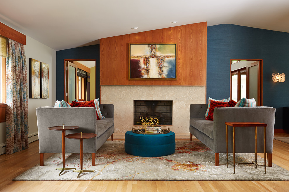 Photo of a midcentury living room in Minneapolis with blue walls and a standard fireplace.