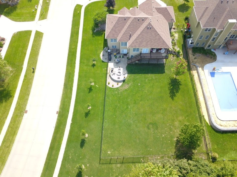 Mid-sized backyard second story privacy and metal railing deck photo with a roof extension