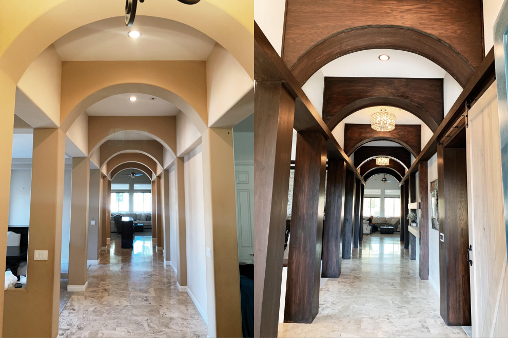 Photo of a large country entry hall in Las Vegas with grey walls, travertine floors, a single front door, a white front door, beige floor, vaulted and panelled walls.