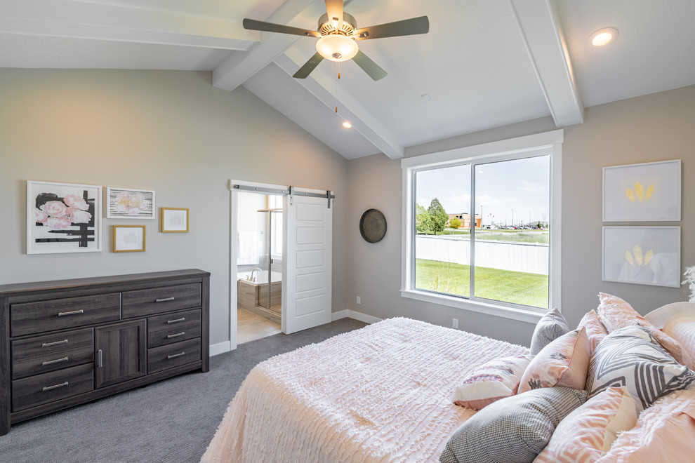 Inspiration for a large country master bedroom in Salt Lake City with beige walls, carpet and grey floor.