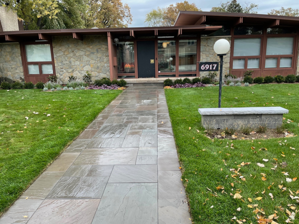 Photo of a mid-sized midcentury front yard full sun garden for summer in Chicago with with path and natural stone pavers.