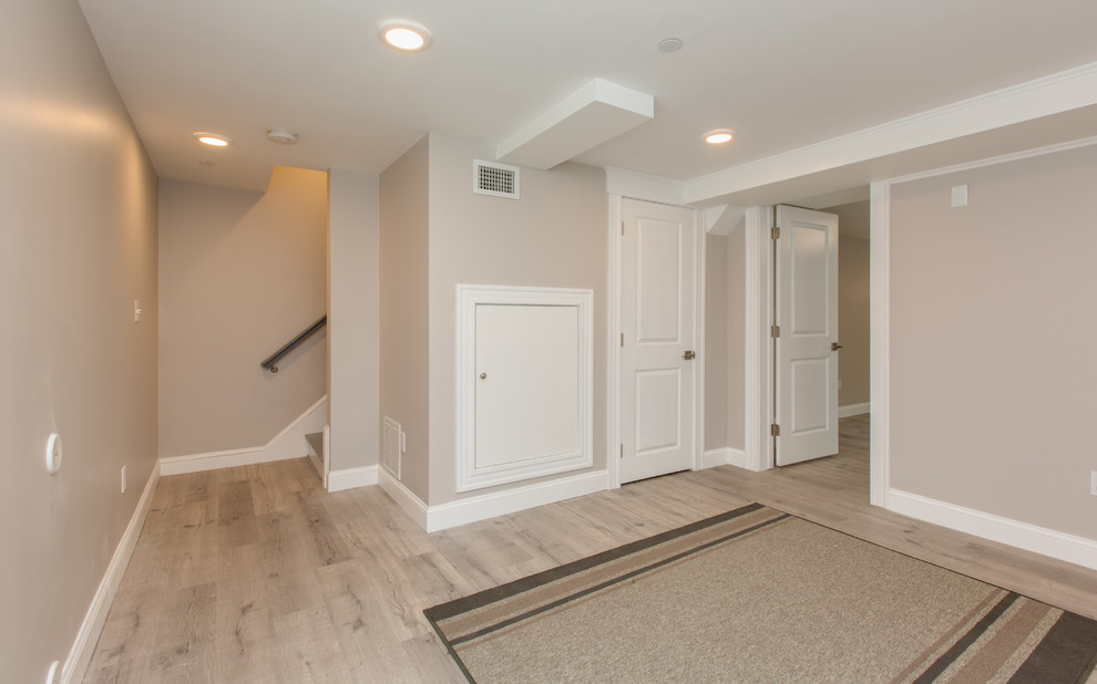Design ideas for a mid-sized transitional home yoga studio in Boston with beige walls, light hardwood floors and beige floor.