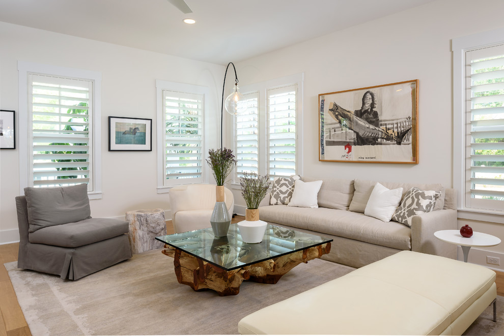 Inspiration for a large beach style open concept family room in Jacksonville with beige walls, light hardwood floors, no fireplace, no tv and beige floor.