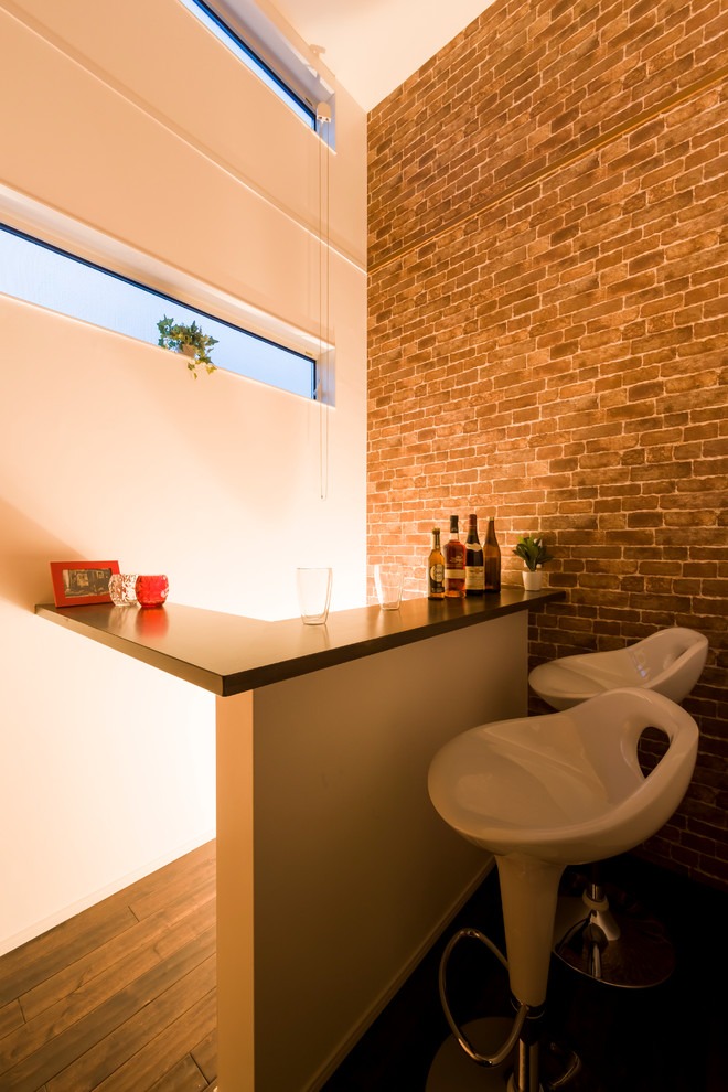 This is an example of a small modern home bar in Other with dark hardwood floors and brown floor.