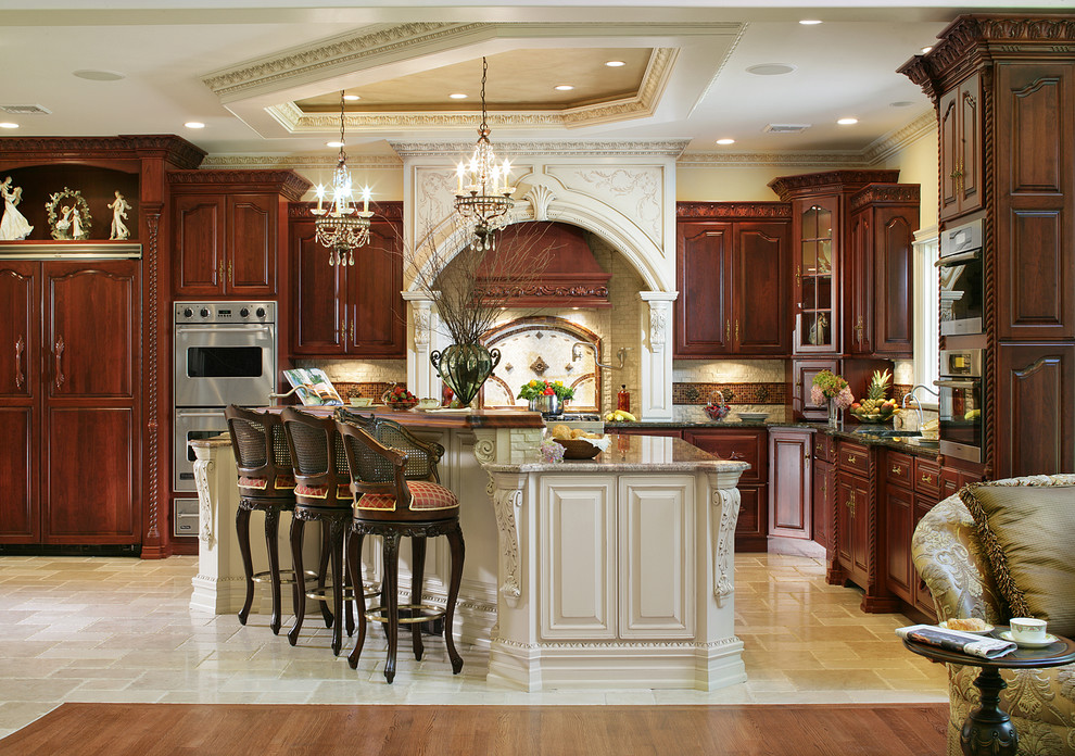 Inspiration for a large traditional l-shaped eat-in kitchen in New York with raised-panel cabinets, dark wood cabinets, beige splashback, stainless steel appliances and with island.