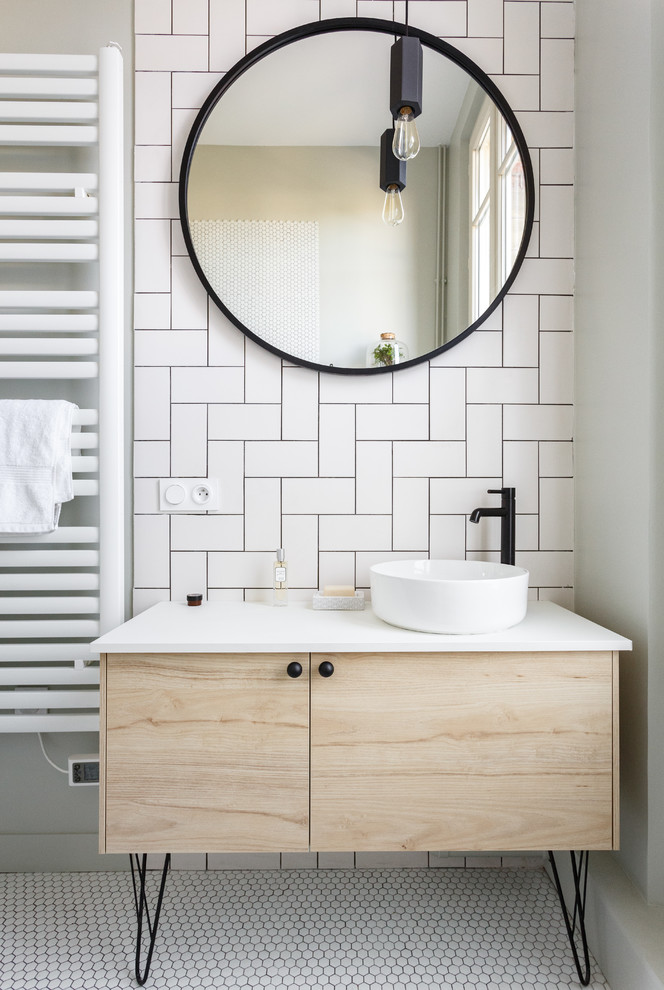 Photo of a mid-sized scandinavian master bathroom in Paris with light wood cabinets, white tile, mosaic tile floors, a vessel sink, white floor, white benchtops, flat-panel cabinets, a drop-in tub, a shower/bathtub combo, a two-piece toilet, porcelain tile, white walls, solid surface benchtops and a hinged shower door.