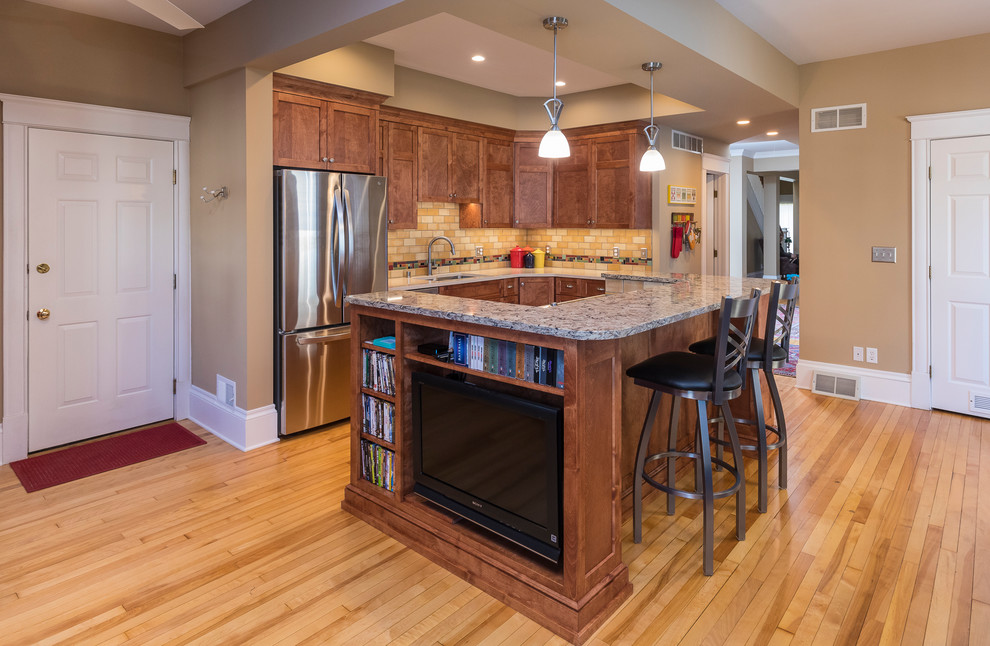 Large l-shaped eat-in kitchen in Minneapolis with a drop-in sink, shaker cabinets, brown cabinets, marble benchtops, multi-coloured splashback, terra-cotta splashback, stainless steel appliances, light hardwood floors, with island, beige floor and beige benchtop.