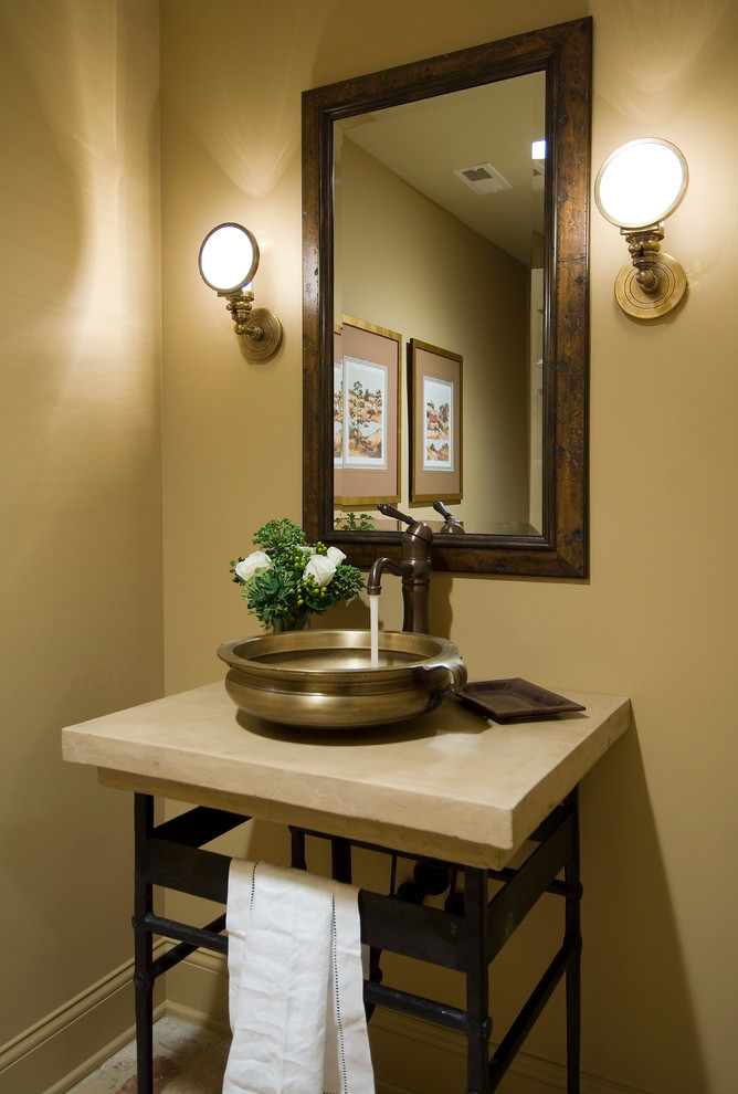 Photo of a traditional powder room in Nashville with a vessel sink and beige benchtops.