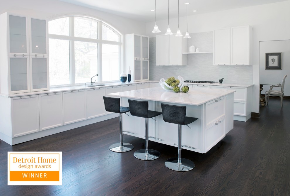 Large transitional u-shaped dark wood floor eat-in kitchen photo with an undermount sink, recessed-panel cabinets, white cabinets, quartzite countertops, white backsplash, paneled appliances, yellow walls and an island