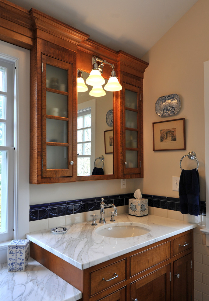 Photo of a traditional bathroom in New York with an undermount sink and marble benchtops.
