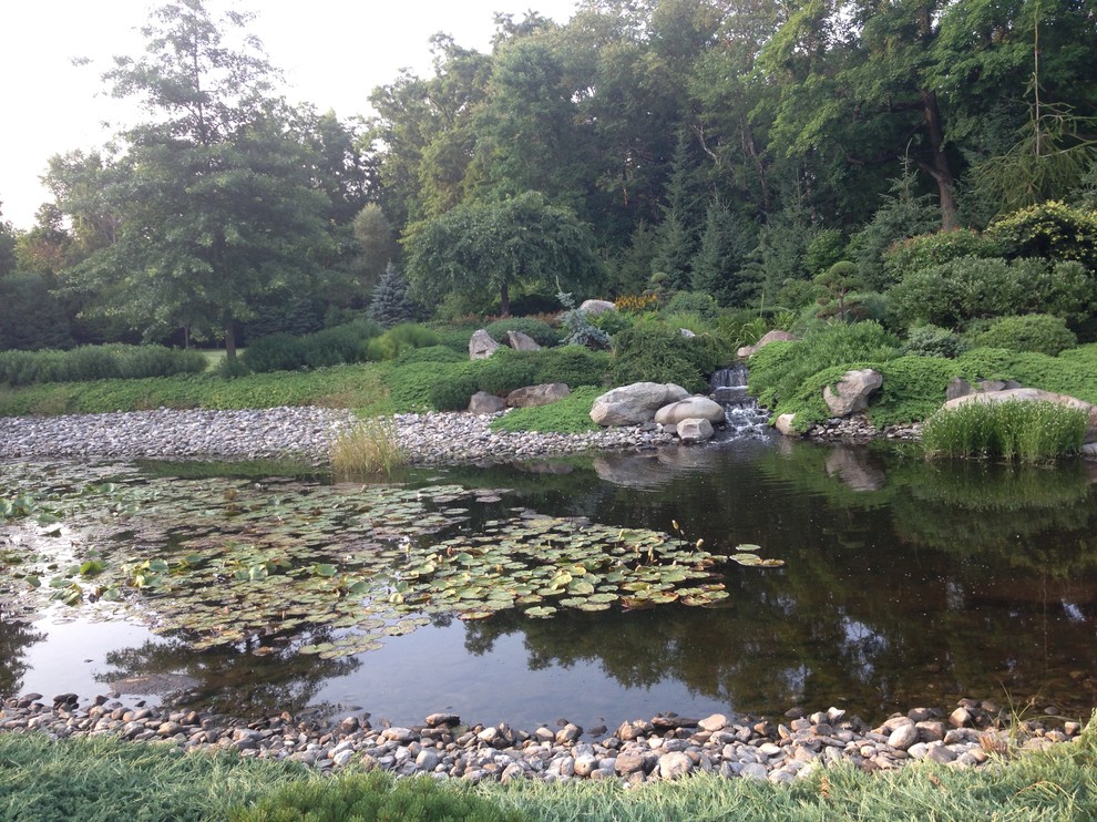 Design ideas for a large traditional backyard water fountain landscape in Boston.