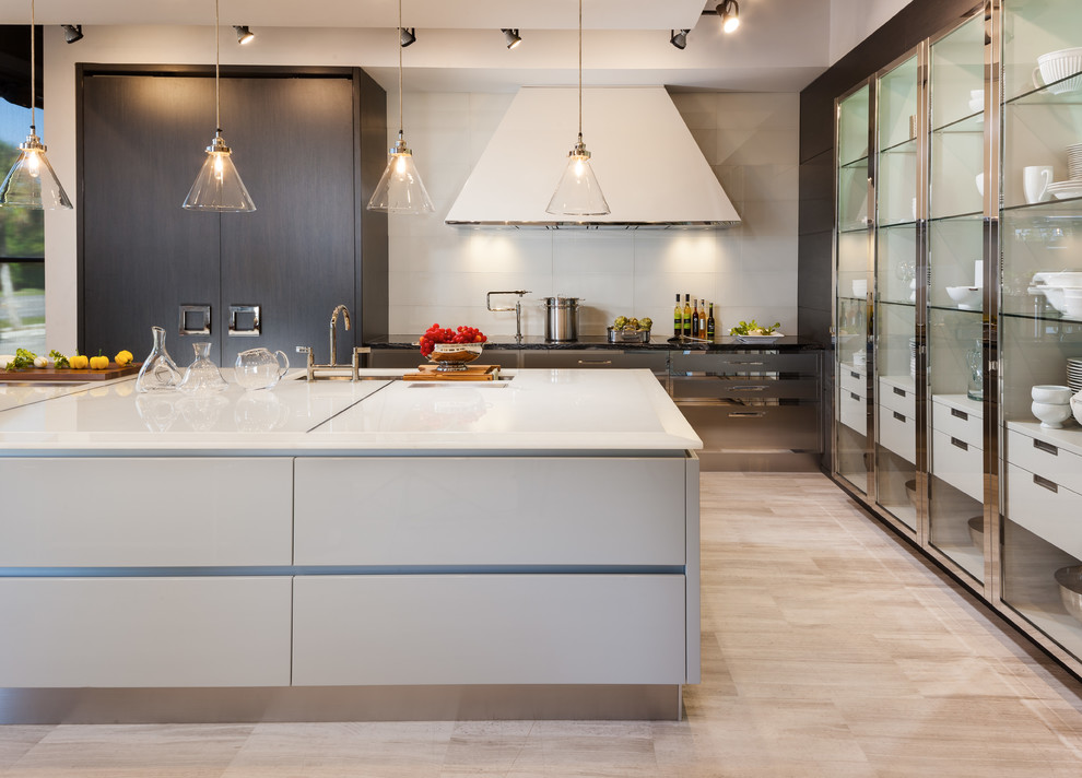 Contemporary kitchen in Miami with flat-panel cabinets, grey cabinets, white splashback and with island.