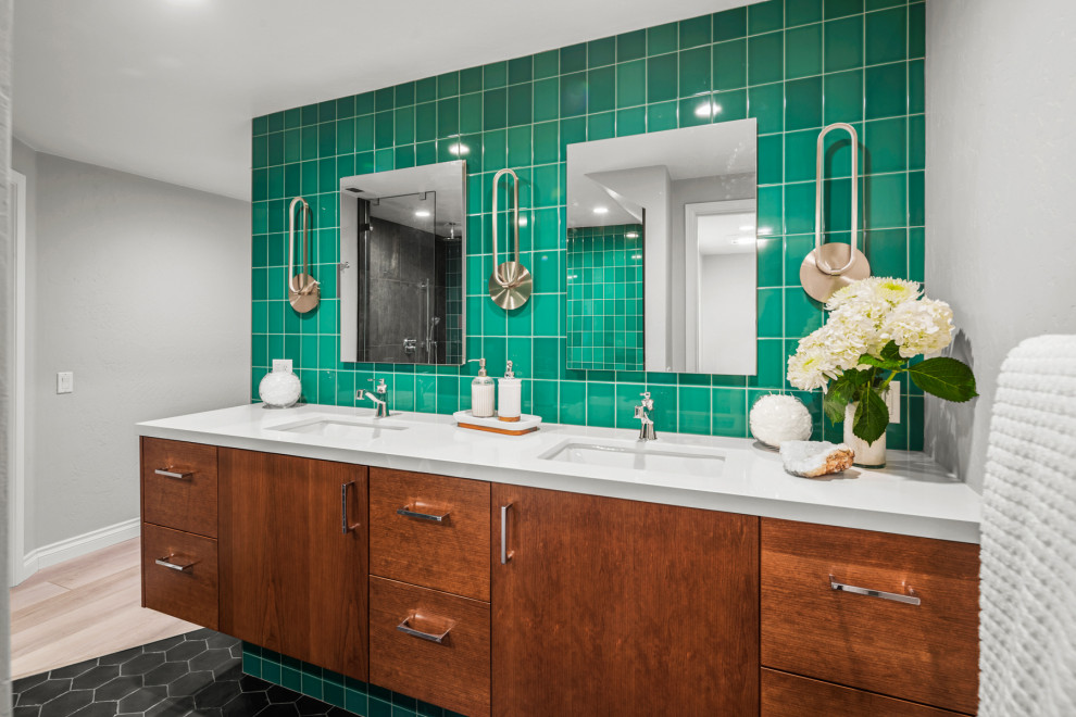 This is an example of a large contemporary master bathroom in San Diego with flat-panel cabinets, brown cabinets, a freestanding tub, a curbless shower, a bidet, green tile, glass tile, grey walls, porcelain floors, an undermount sink, engineered quartz benchtops, black floor, an open shower, white benchtops, an enclosed toilet, a double vanity and a floating vanity.