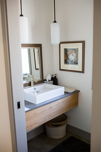 Mid-sized mountain style master gray tile and subway tile concrete floor and gray floor freestanding bathtub photo with shaker cabinets, white cabinets, a two-piece toilet, an undermount sink, granite countertops and a hinged shower door