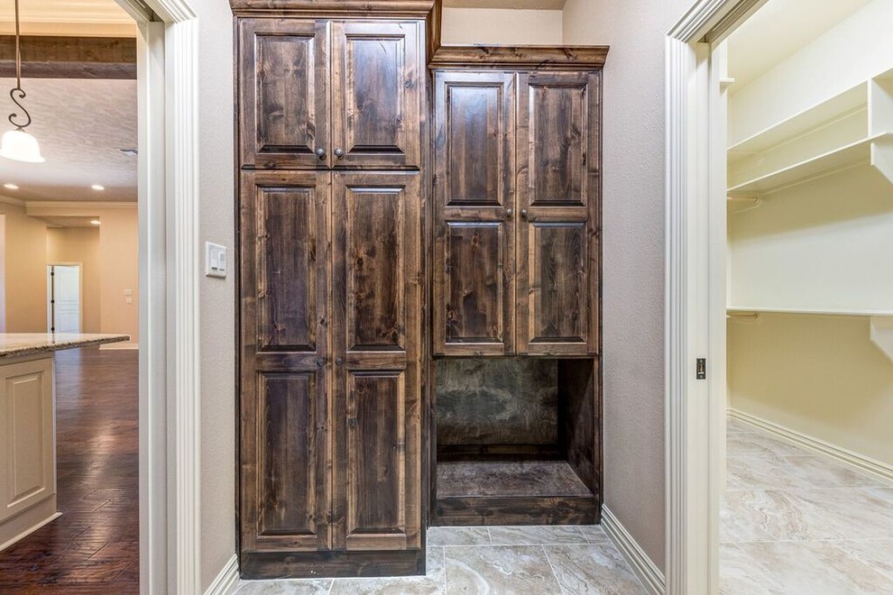 Kitchen pantry - mid-sized traditional u-shaped dark wood floor and brown floor kitchen pantry idea with an undermount sink, raised-panel cabinets, dark wood cabinets, granite countertops, beige backsplash, ceramic backsplash, stainless steel appliances and an island