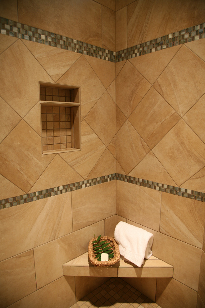 Photo of a large traditional master bathroom in Milwaukee with recessed-panel cabinets, green cabinets, an alcove shower, a one-piece toilet, multi-coloured tile, mosaic tile, green walls, an undermount sink, quartzite benchtops, beige floor, a hinged shower door and beige benchtops.