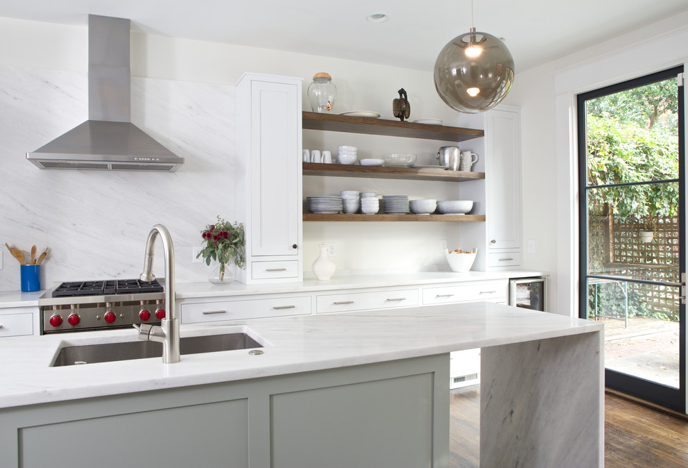 Inspiration for a mid-sized transitional galley separate kitchen in Atlanta with marble benchtops, white splashback, with island and brown floor.