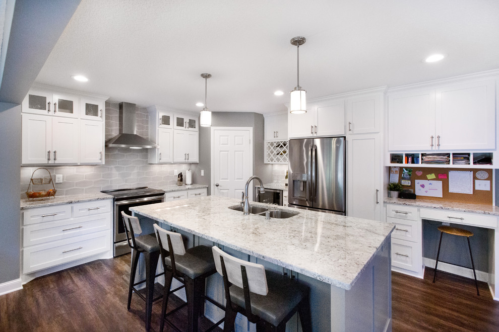 Mid-sized transitional l-shaped vinyl floor and brown floor eat-in kitchen photo in Minneapolis with an undermount sink, shaker cabinets, white cabinets, granite countertops, gray backsplash, ceramic backsplash, stainless steel appliances, an island and multicolored countertops