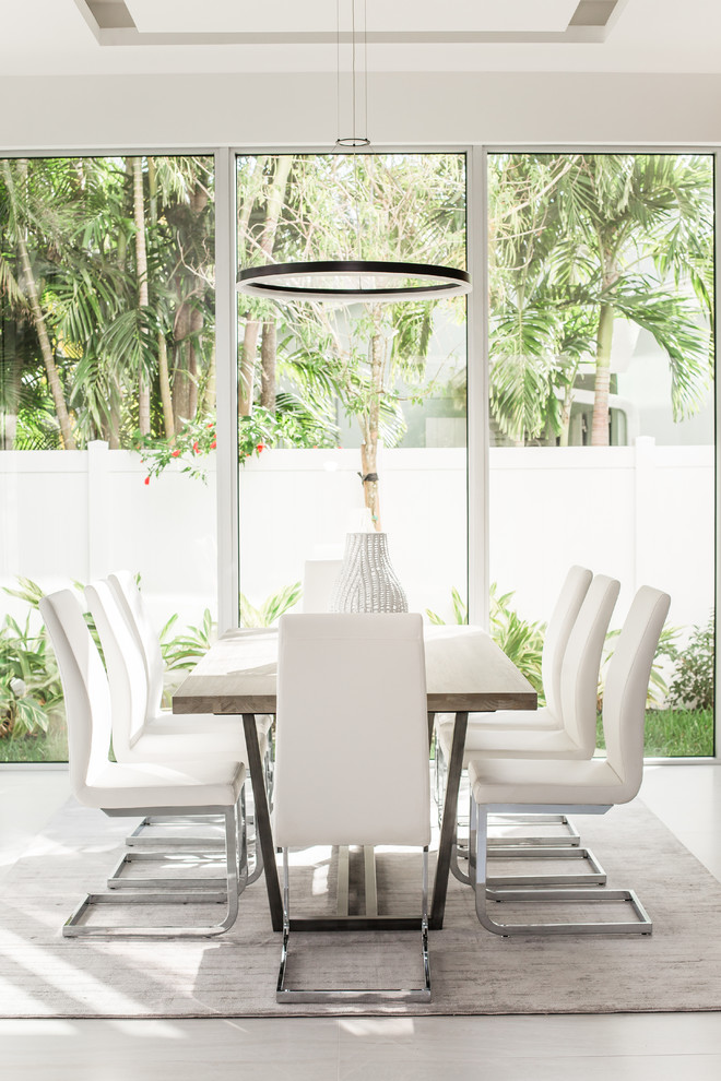 Inspiration for a contemporary painted wood floor and gray floor dining room remodel in Miami