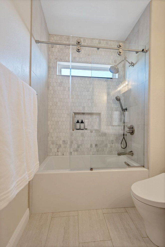 Design ideas for a mid-sized transitional kids bathroom in Phoenix with recessed-panel cabinets, brown cabinets, an alcove tub, a shower/bathtub combo, a bidet, white tile, marble, beige walls, an undermount sink, engineered quartz benchtops, a sliding shower screen, white benchtops, a niche, a double vanity and a built-in vanity.