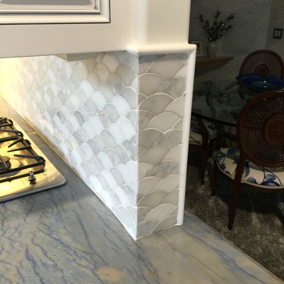 Small eclectic eat-in kitchen photo with raised-panel cabinets, white cabinets, granite countertops, white backsplash and mosaic tile backsplash