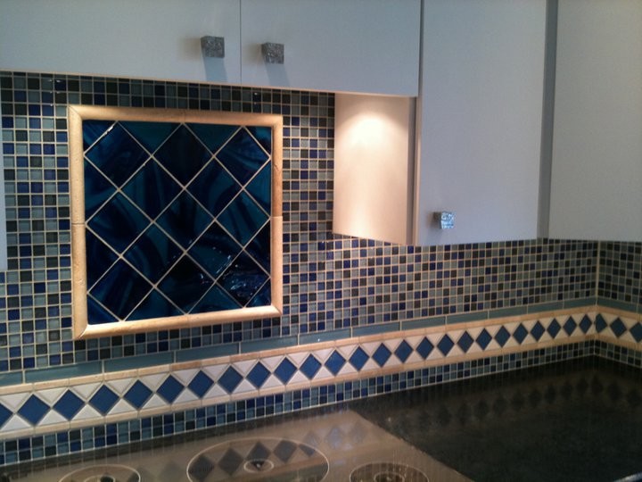 Transitional kitchen photo in Chicago with flat-panel cabinets, white cabinets, blue backsplash and mosaic tile backsplash