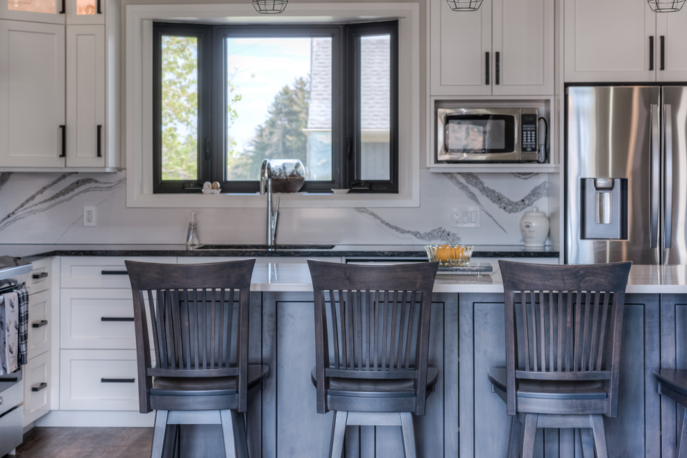 Eat-in kitchen - transitional eat-in kitchen idea with shaker cabinets, white cabinets, stainless steel appliances and an island