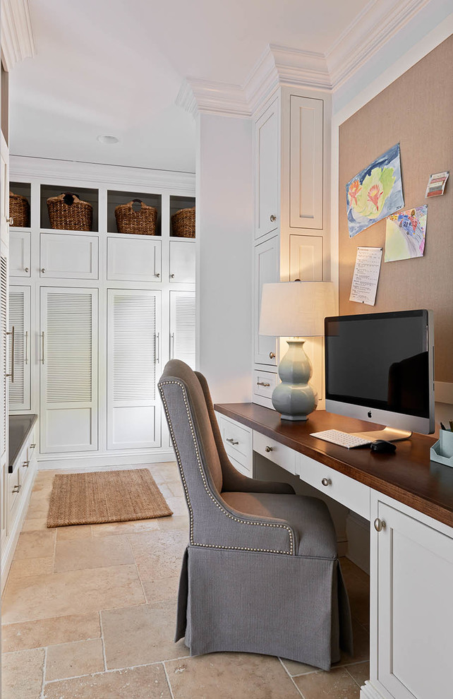 Inspiration for a traditional study room in Charlotte with white walls, no fireplace, a built-in desk and beige floor.