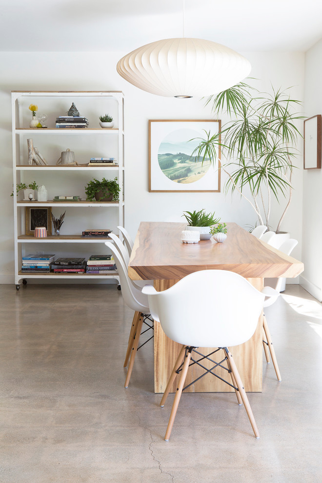 Photo of a scandinavian dining room in Los Angeles with white walls.
