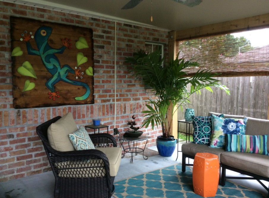 Design ideas for a mid-sized traditional backyard patio in New Orleans with a fire feature, concrete slab and a roof extension.