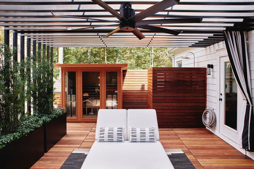 Design ideas for a mid-sized modern rooftop and first floor deck in Raleigh with an outdoor shower, a pergola and metal railing.