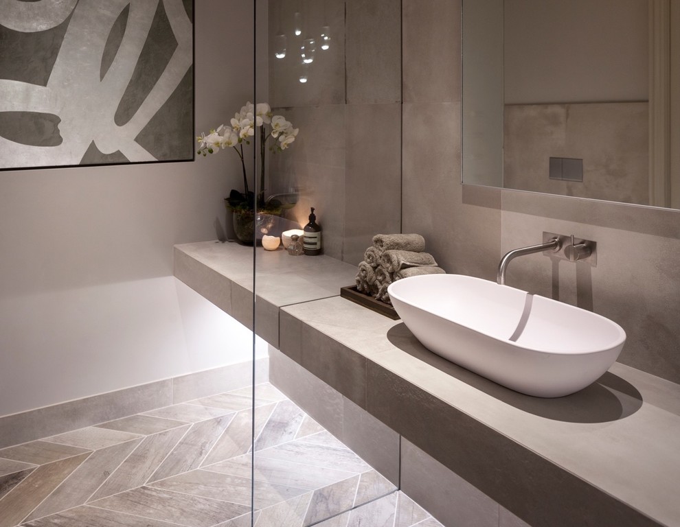 Design ideas for a mid-sized contemporary master bathroom in Cheshire with a trough sink, furniture-like cabinets, distressed cabinets, a freestanding tub, a shower/bathtub combo, a wall-mount toilet, white tile, porcelain tile, white walls and porcelain floors.