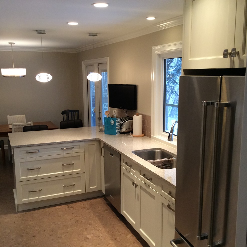 Inspiration for a transitional cork floor kitchen remodel in Edmonton with white cabinets, quartzite countertops, gray backsplash, ceramic backsplash and stainless steel appliances