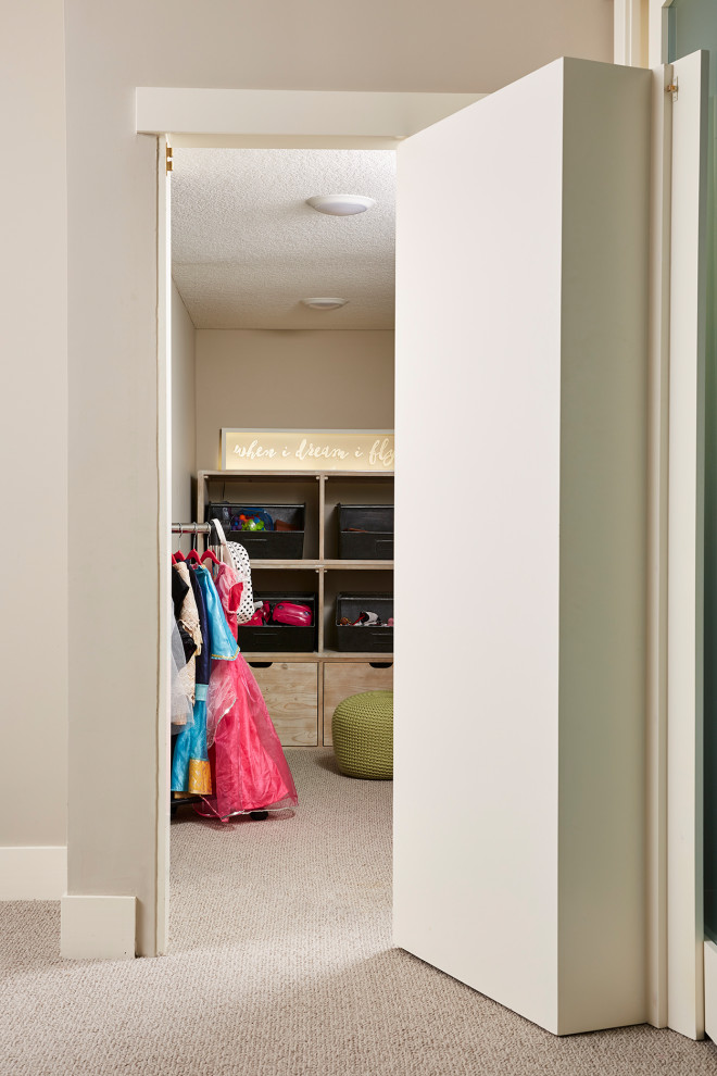 Photo of a small traditional kids' playroom for kids 4-10 years old and girls in Minneapolis with grey walls, carpet and grey floor.