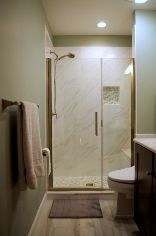 Small transitional master gray tile and porcelain tile porcelain tile and brown floor alcove shower photo in Chicago with shaker cabinets, dark wood cabinets, a one-piece toilet, gray walls, an undermount sink and quartz countertops