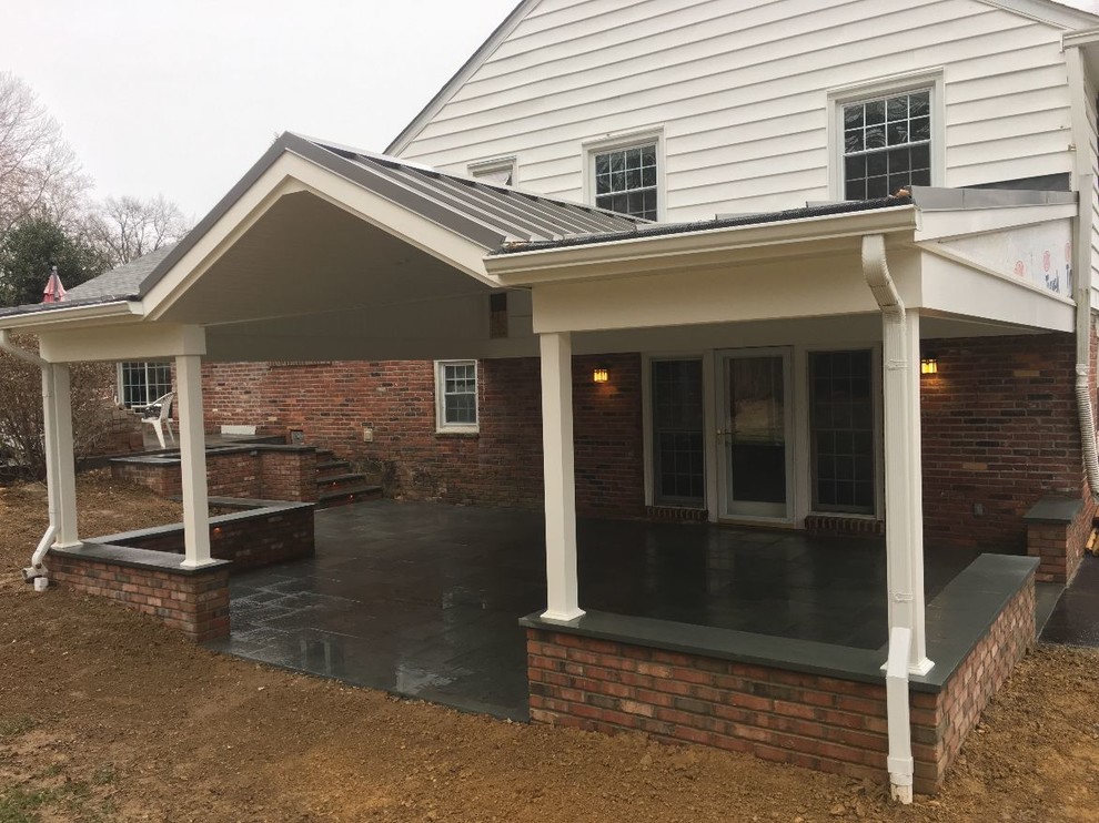 Patio with brick sitting walls and steps and new roof
