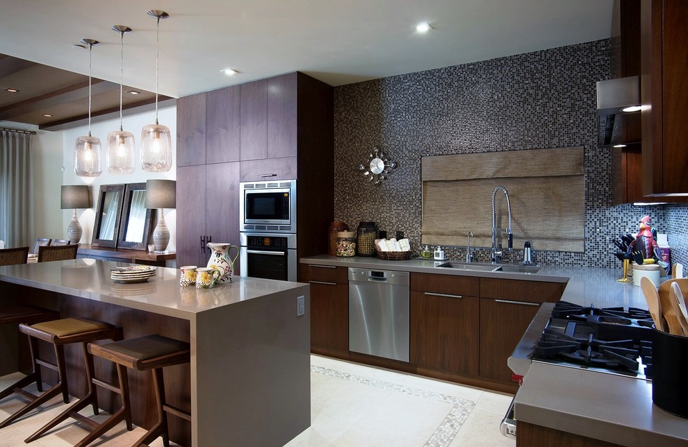 Photo of a large contemporary l-shaped open plan kitchen in San Diego with a double-bowl sink, flat-panel cabinets, dark wood cabinets, quartz benchtops, multi-coloured splashback, mosaic tile splashback, stainless steel appliances, limestone floors, with island and beige floor.
