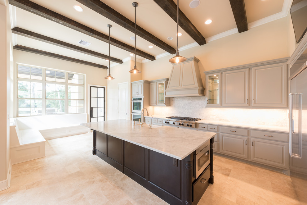Inspiration for a huge transitional l-shaped porcelain tile and beige floor open concept kitchen remodel in Houston with a farmhouse sink, raised-panel cabinets, gray cabinets, marble countertops, gray backsplash, subway tile backsplash, stainless steel appliances, an island and white countertops