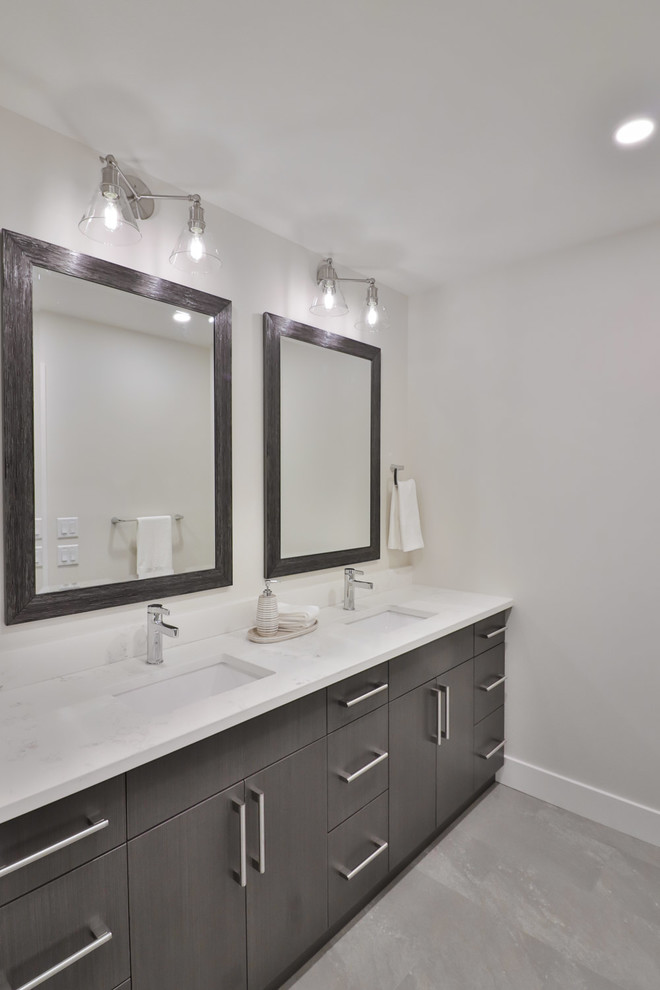 Large transitional kids' white tile and porcelain tile vinyl floor and gray floor bathroom photo with flat-panel cabinets, gray cabinets, a two-piece toilet, gray walls, an undermount sink and quartz countertops