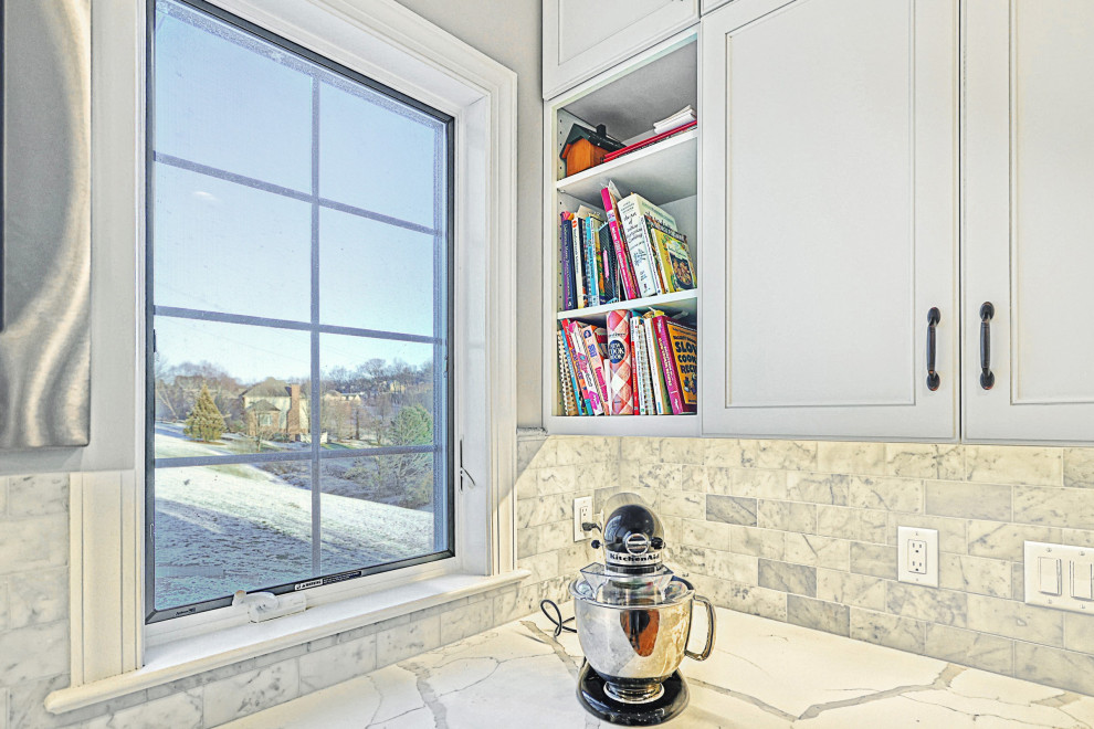 Eat-in kitchen - huge transitional u-shaped medium tone wood floor and brown floor eat-in kitchen idea with an undermount sink, beaded inset cabinets, dark wood cabinets, quartz countertops, multicolored backsplash, marble backsplash, stainless steel appliances, an island and white countertops