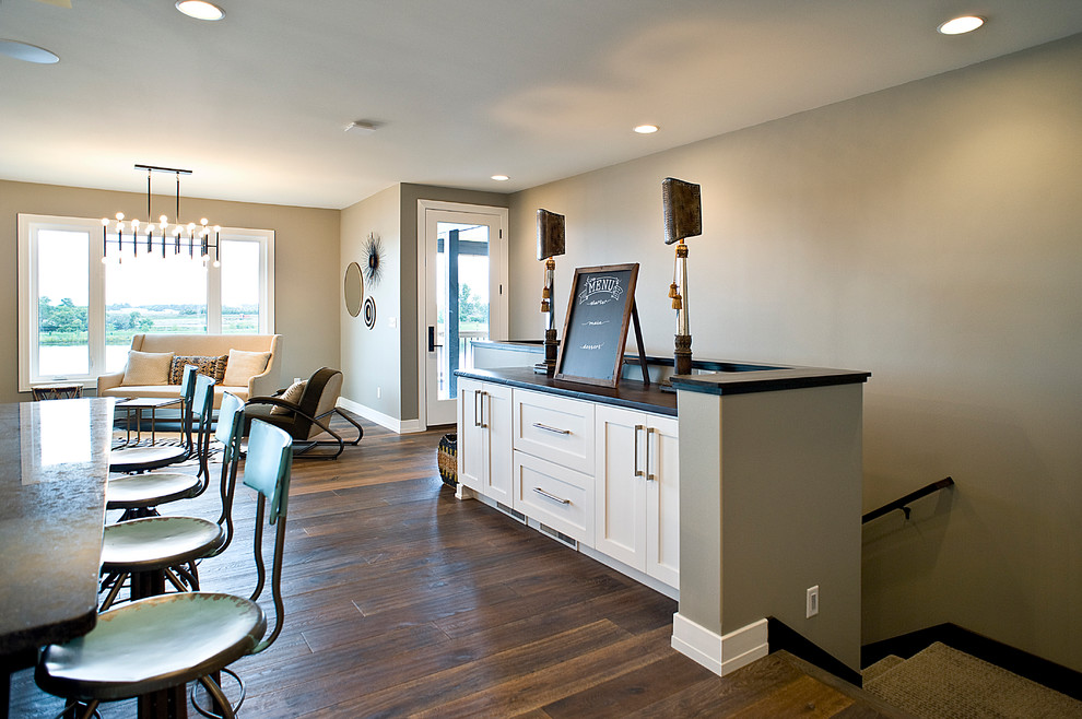 Inspiration for a large transitional l-shaped dark wood floor and brown floor eat-in kitchen remodel with beige walls, an undermount sink, shaker cabinets, white cabinets, granite countertops, white backsplash, subway tile backsplash, stainless steel appliances and an island