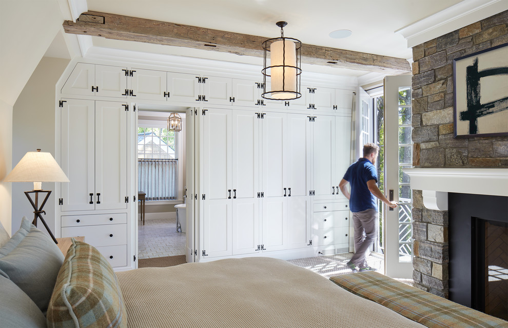 Inspiration for a large coastal master carpeted and brown floor bedroom remodel in Minneapolis with a standard fireplace and beige walls