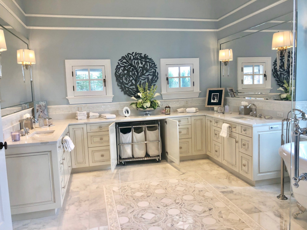 Design ideas for an expansive transitional master bathroom in New York with furniture-like cabinets, white cabinets, a freestanding tub, a bidet, white tile, marble, blue walls, marble floors, an undermount sink, quartzite benchtops, grey floor, a hinged shower door and white benchtops.