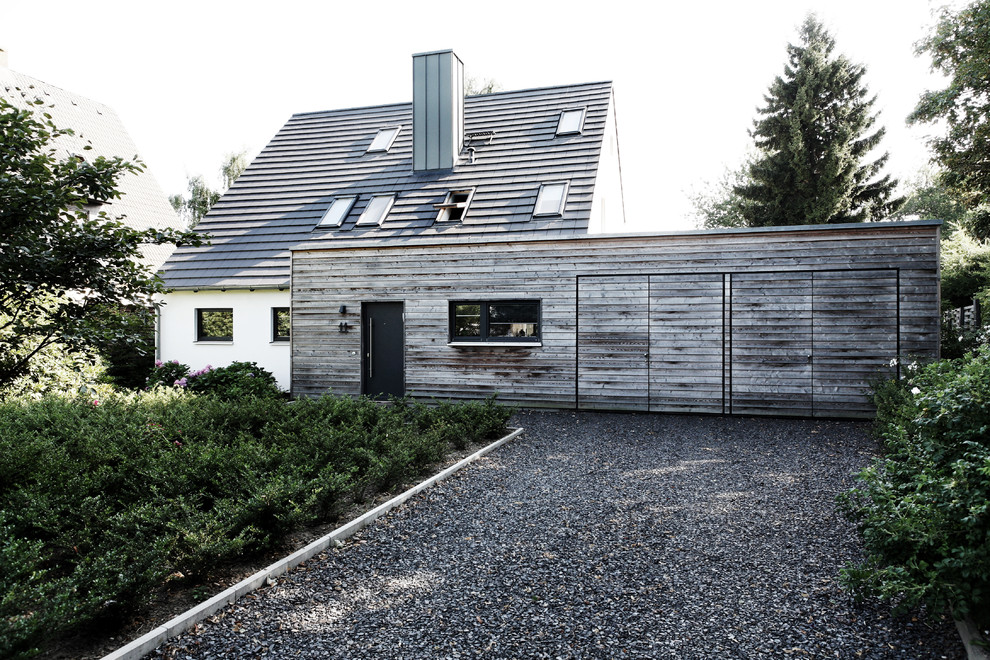 Inspiration for a mid-sized contemporary two-storey exterior in Hamburg with mixed siding.